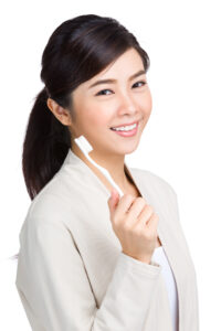 woman holding toothbrush 2023 11 27 05 23 30 utc